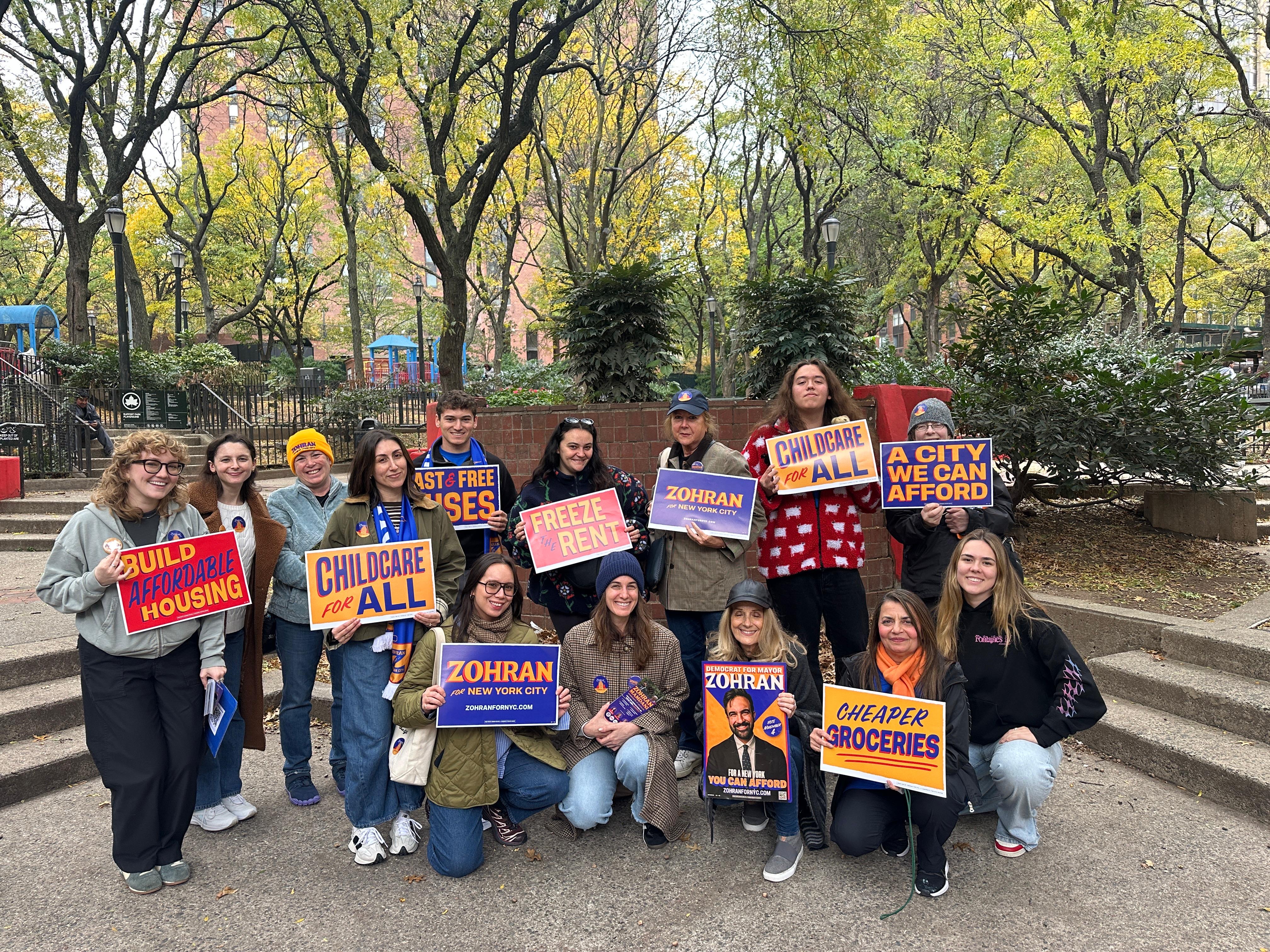 Zohran volunteers with signs